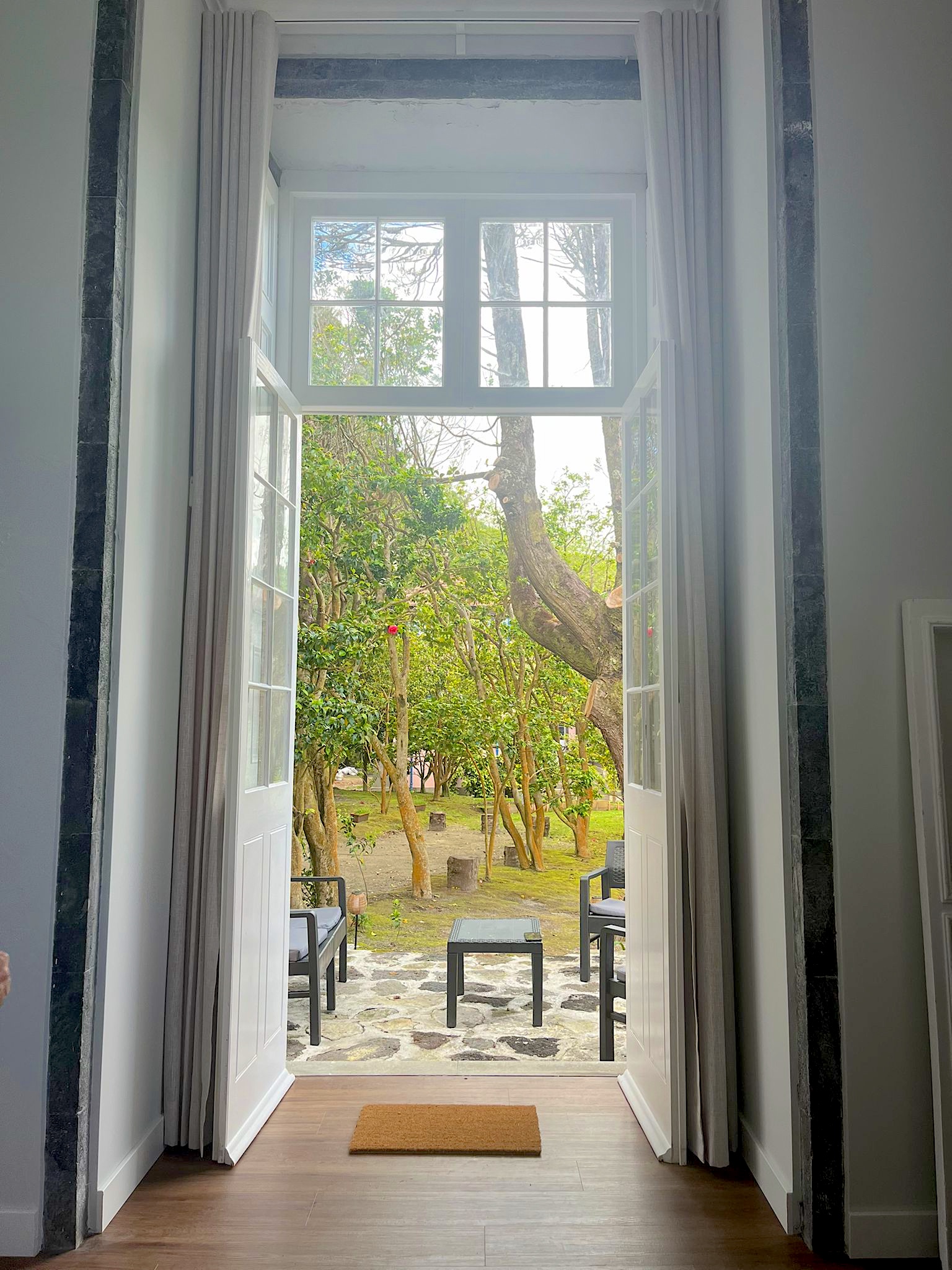 Garden doors opening onto the lakeside lounge